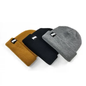 Zev beanies on a white background. Available in Black, Grey, and Burnt Orange